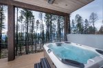 The lower level patio leads to the home`s private hot tub with lake and mountain views.